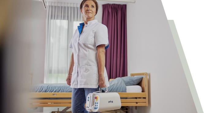 Nurse proudly carying PLS AR-200P Portable Ceiling Lift